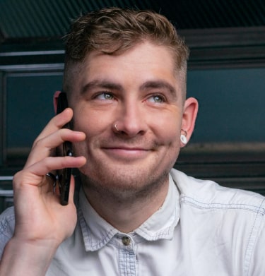 Smiling AnswerConnect employee on his mobile phone