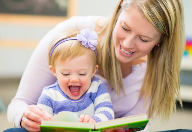 woman reading a book for a child